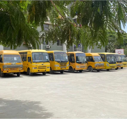 Fleet of Yellow School Buses Parked at Campus Grounds