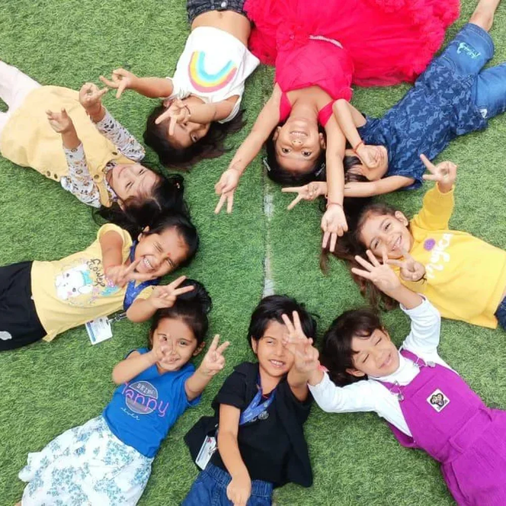 Children Lying in a Circle on Grass
