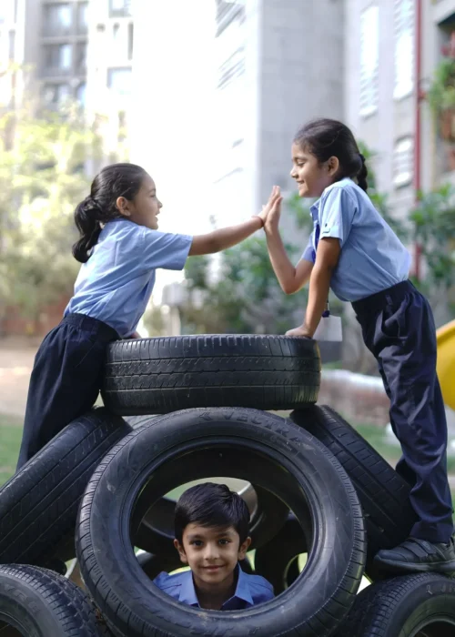 School Children Playing on Tire