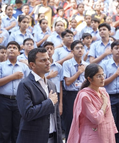 School Assembly Gathering with Guests and Students Reciting Pledge