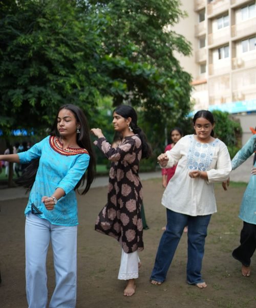 Students Rehearsing Dance Steps Outdoors for School Cultural Event