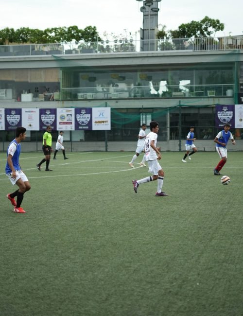 Students Playing Football Match Action on Artificial Turf Field