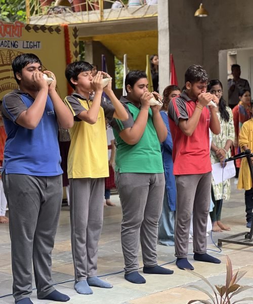 Students Blowing Conch Shells During School Event Ceremony